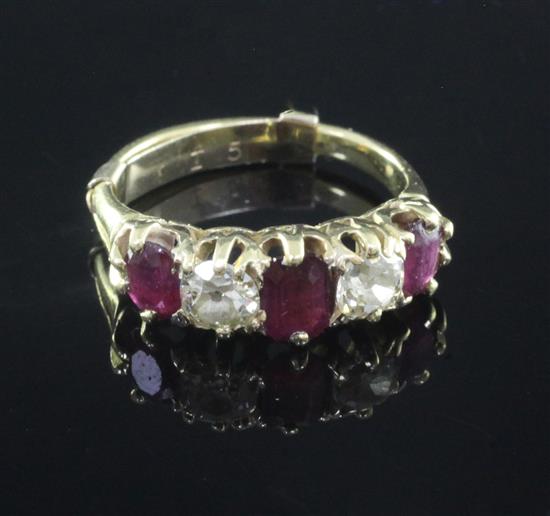 A gold and graduated five stone ruby and diamond set half hoop ring, size K.